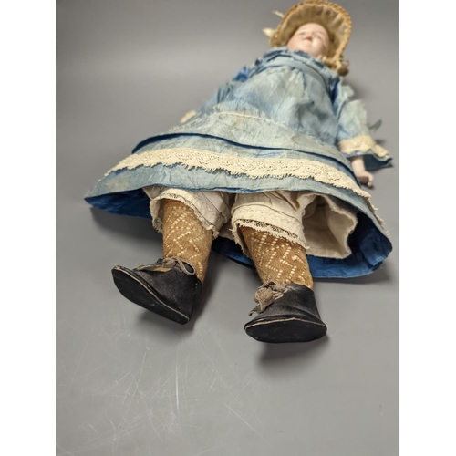 1378 - A German bisque headed doll, wearing a blue silk dress and straw bonnet, 42 cms high.