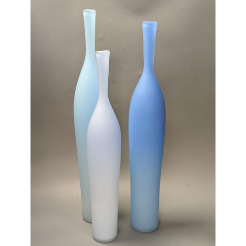 1379 - Three contemporary blue glass bottle vases,tallest 55cms high.