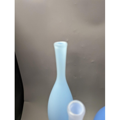 1379 - Three contemporary blue glass bottle vases,tallest 55cms high.