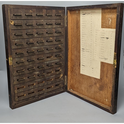 1393 - An early 20th century textile mill clocking in board with engraved numbered tokens