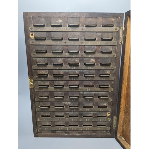 1393 - An early 20th century textile mill clocking in board with engraved numbered tokens