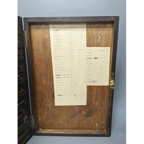 1393 - An early 20th century textile mill clocking in board with engraved numbered tokens