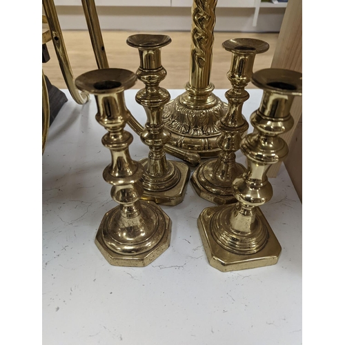 1394 - A brass magazine stand, a pair of scales, four candlesticks and a tall brass oil lamp base,Oil lamp ... 