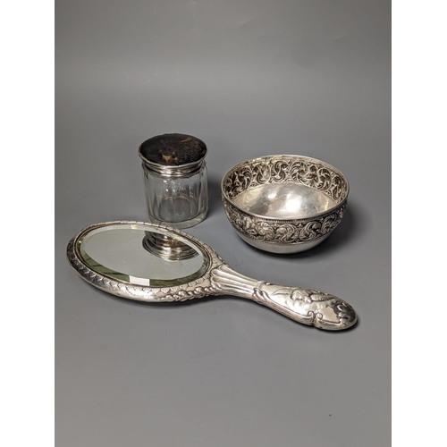 1805 - An Edwardian silver mounted 'Reynold's Angels' hand mirror, a silver and tortoiseshell lidded glass ... 