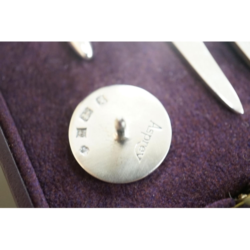 1807 - A modern Asprey cased silver golfer's companion set, comprising a tee, marker and pitch mark repaire... 