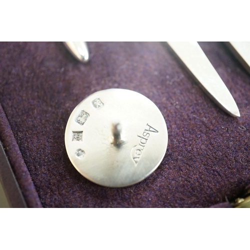 1807 - A modern Asprey cased silver golfer's companion set, comprising a tee, marker and pitch mark repaire... 