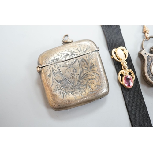 1808 - A silver vesta case, 48mm and a white metal cased fob watch,  on a black sash suspension.... 