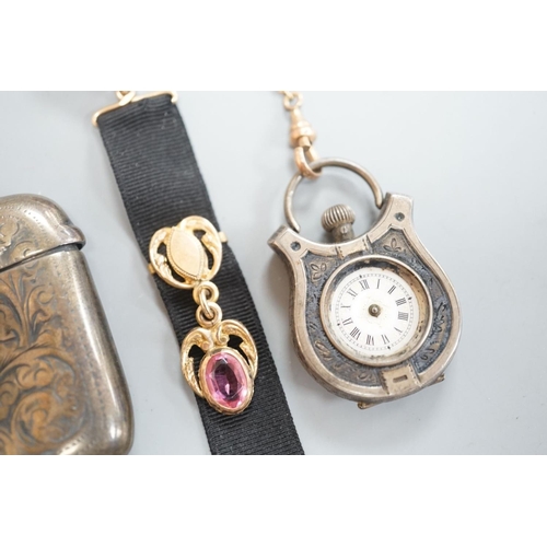 1808 - A silver vesta case, 48mm and a white metal cased fob watch,  on a black sash suspension.... 