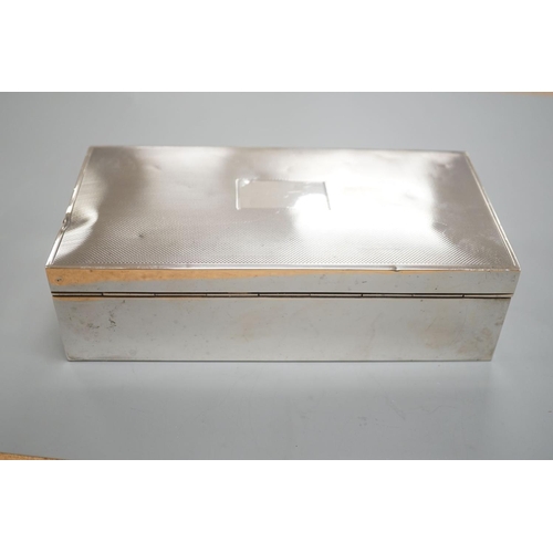 1825 - A late 1950's engine turned silver mounted rectangular cigarette box, with engraved inscription, 17.... 