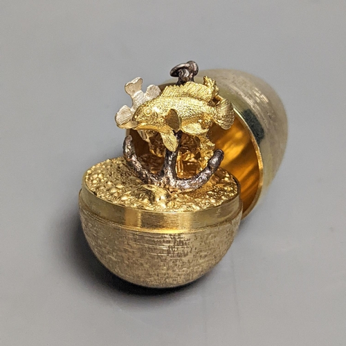 1834 - A 1970's textured silver gilt surprise egg by Stuart Devlin, opening to reveal a ship's anchor with ... 