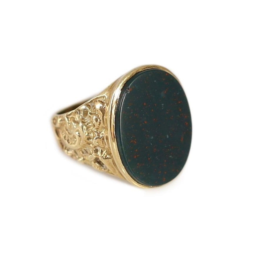 1877 - A 1970's 9ct gold and oval bloodstone set signet ring,with ornate carved shoulders, size P/Q, gross ... 