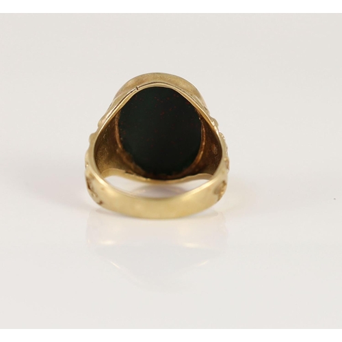 1877 - A 1970's 9ct gold and oval bloodstone set signet ring,with ornate carved shoulders, size P/Q, gross ... 