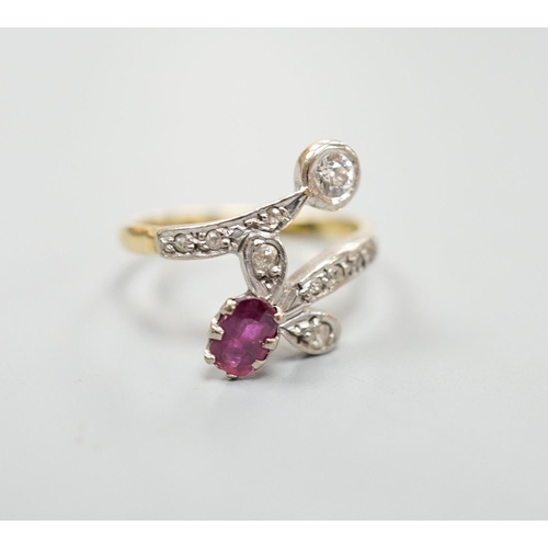 1950 - An early to mid 20th century 18ct, ruby and diamond set crossover ring, with diamond set shoulders, ... 