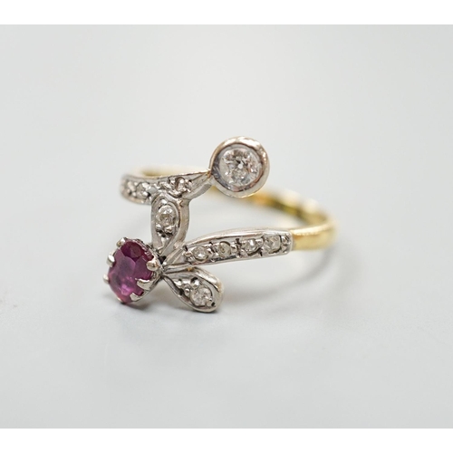 1950 - An early to mid 20th century 18ct, ruby and diamond set crossover ring, with diamond set shoulders, ... 