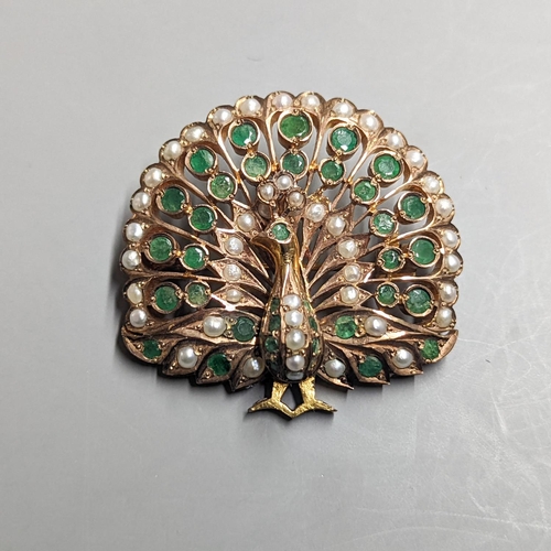 1952 - An Indian? gilt metal emerald and seed pearl cluster set peacock pendant brooch, height 45mm.... 