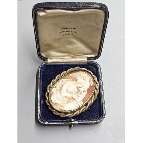 1954 - A late Victorian gilt metal mounted oval cameo shell brooch, carved with Leda & the Swan, 72mm.... 