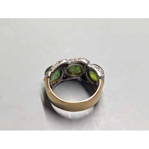 1956 - A modern 585 yellow metal, three stone green cabochon and diamond chip set dress ring, size N/O, gro... 