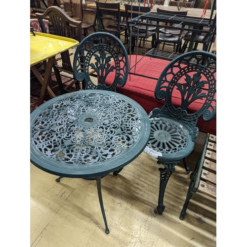 1061 - A circular painted aluminium garden table, diameter 60cm, height 62cm together with two chairs... 
