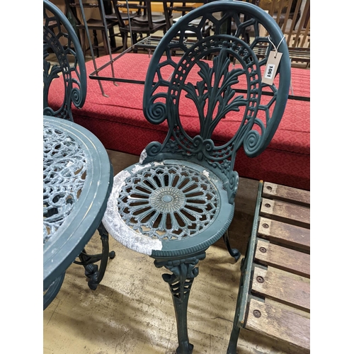 1061 - A circular painted aluminium garden table, diameter 60cm, height 62cm together with two chairs... 