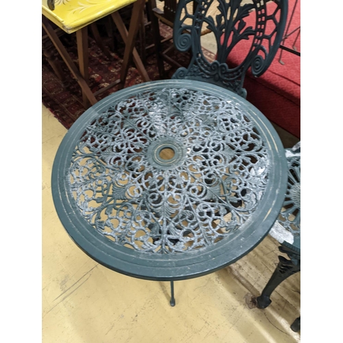 1061 - A circular painted aluminium garden table, diameter 60cm, height 62cm together with two chairs... 