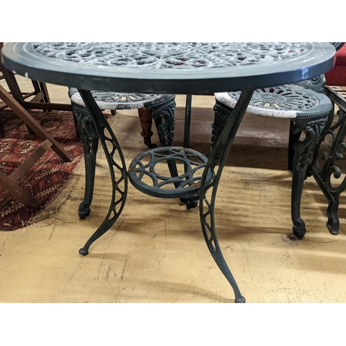 1061 - A circular painted aluminium garden table, diameter 60cm, height 62cm together with two chairs... 