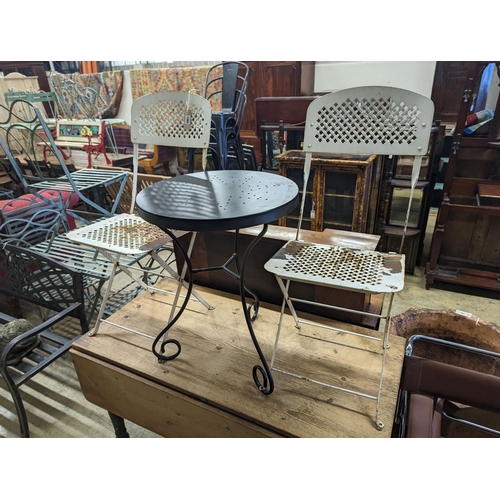 1065 - A circular metal bistro table, diameter 49cm, height 65cm and two chairs