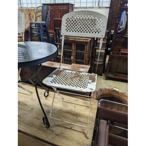1065 - A circular metal bistro table, diameter 49cm, height 65cm and two chairs
