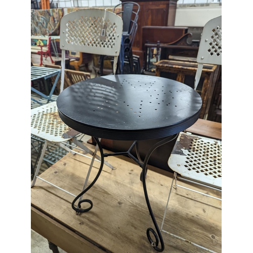 1065 - A circular metal bistro table, diameter 49cm, height 65cm and two chairs