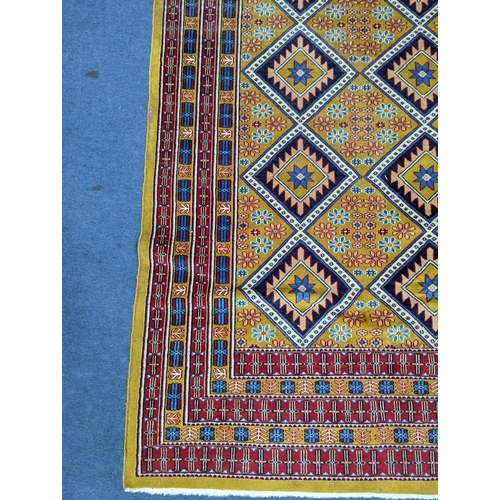 1084 - A Caucasian style gold ground rug, 190 x 124cm