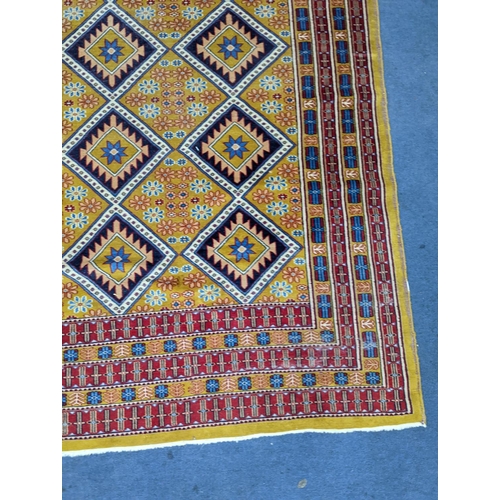 1084 - A Caucasian style gold ground rug, 190 x 124cm