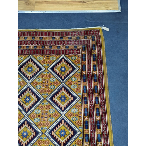 1084 - A Caucasian style gold ground rug, 190 x 124cm