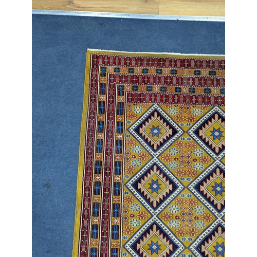 1084 - A Caucasian style gold ground rug, 190 x 124cm