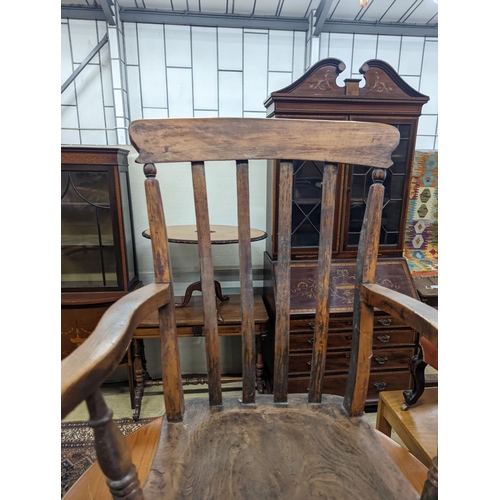 1111 - A Victorian elm and beech Windsor lathe back elbow chair, width 58cm, depth 47cm, height 109cm... 