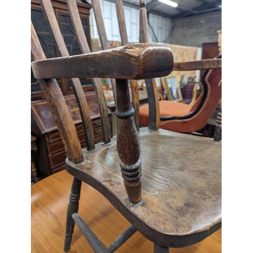 1111 - A Victorian elm and beech Windsor lathe back elbow chair, width 58cm, depth 47cm, height 109cm... 
