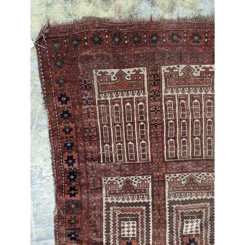 27 - An Afghan red ground prayer rug, 166 x 120cm