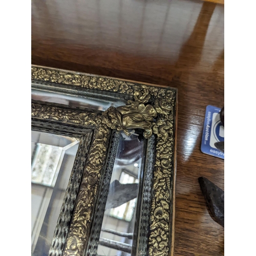 32 - A 19th century Dutch embossed brass wall mirror, width 45cm, height 75cm