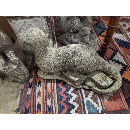 42 - Four reconstituted stone garden ornaments modelled as a flower seller, height 102cm, hare, seal and ... 