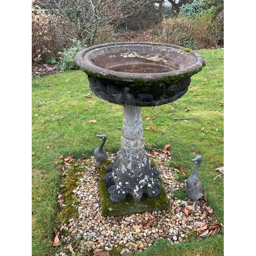 1002 - A circular reconstituted stone bird bath, diameter 56cm, height 89cm