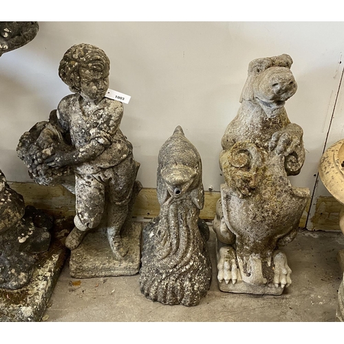 1003 - Three reconstituted stone garden ornaments, flower seller, dolphin and heraldic lion, largest height... 