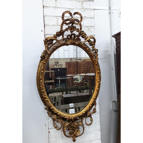 1006 - A late Victorian giltwood and gesso oval framed wall mirror, width 54cm, height 100cm