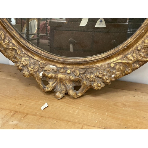 1022 - An oval giltwood and gesso wall mirror, width 89cm, height 108cm