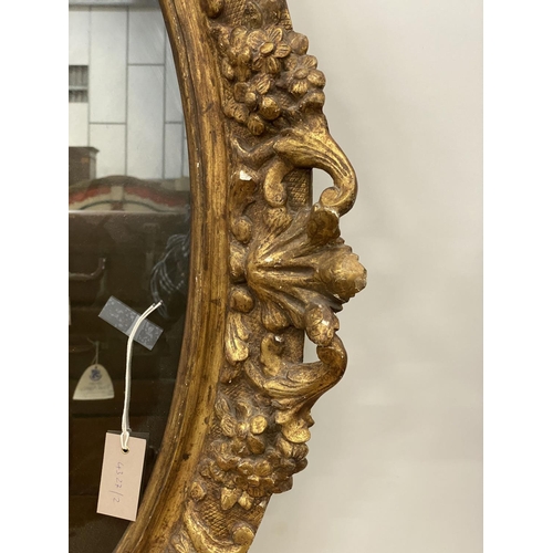 1022 - An oval giltwood and gesso wall mirror, width 89cm, height 108cm