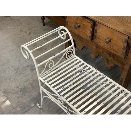 1023 - A painted wrought iron scroll end garden bench, length 130cm, depth 34cm, height 61cm