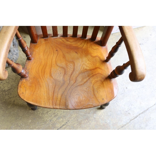 1037 - A Victorian elm and beech Windsor lathe back armchair.