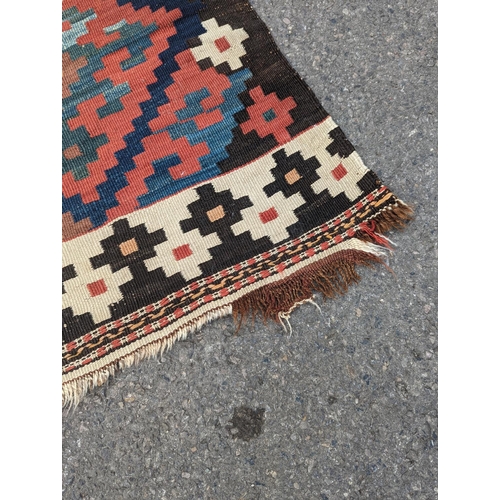 1048 - A Persian tribal Kelim carpet, 230 x 158cm and a Turkish bag