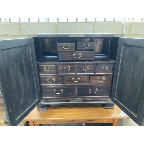 1086 - A Korean brass mounted pine table cabinet fitted with an arrangement of drawers, width 70cm, depth 4... 