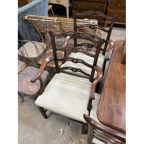 1100 - A set of six Chippendale style mahogany dining chairs with pierced ladder backs, two with arms... 