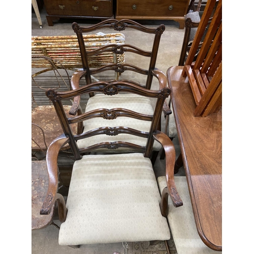 1100 - A set of six Chippendale style mahogany dining chairs with pierced ladder backs, two with arms... 