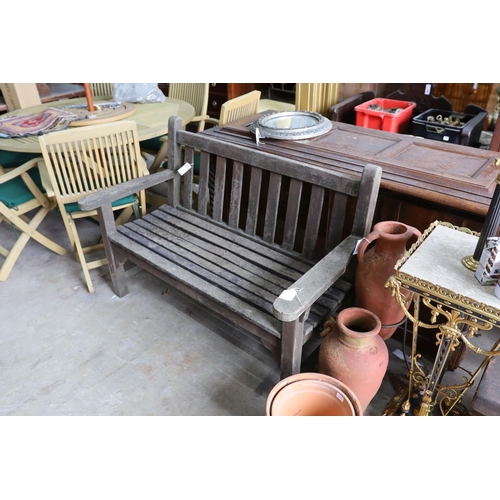 1121 - A weathered teak slatted garden bench, length 128cm, depth 62cm, height 91cm