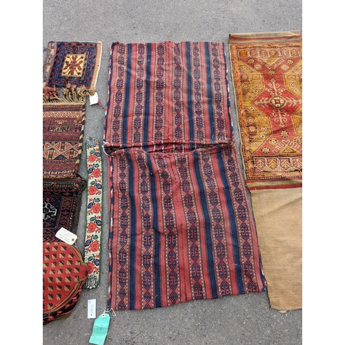 1126 - An Afghan Kilim flatweave saddlebag, 144 x 69cm together with six assorted bags, faces, etc.... 